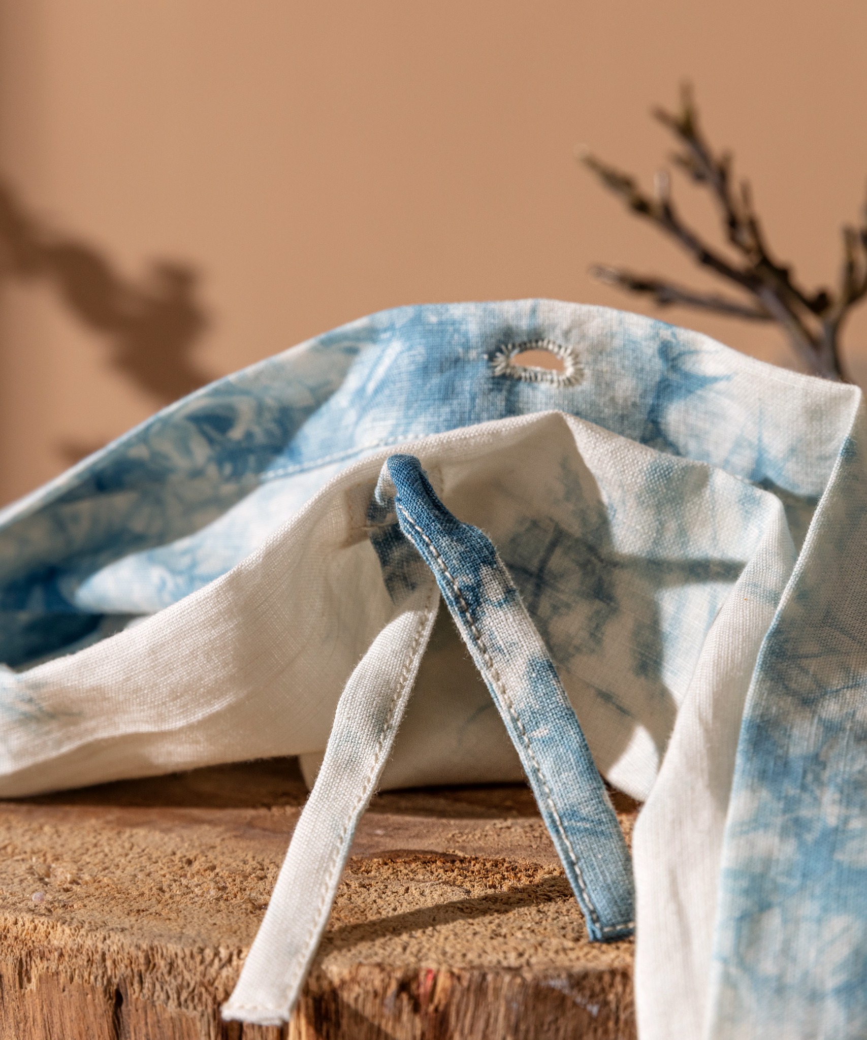 Hands preparing indigo-dyed fabric as part of a botanical dye process