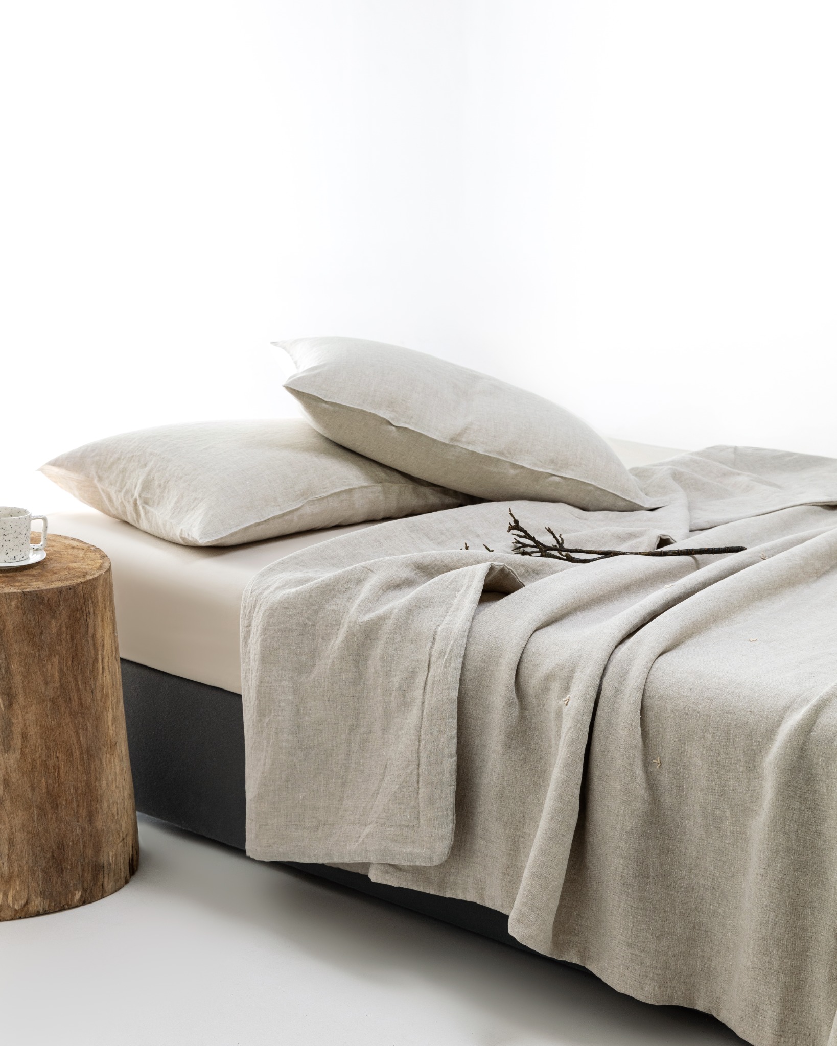 Natural undyed linen quilt and pillows in a quiet bedroom